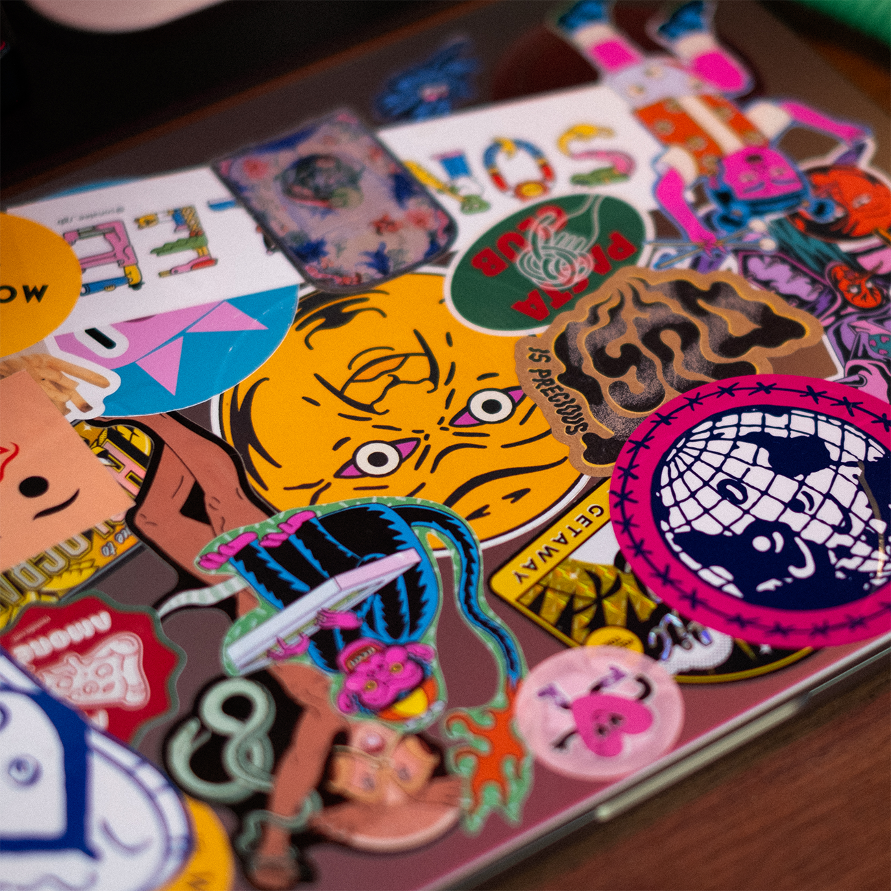 laptop covered in die-cut stickers on different sticker materials