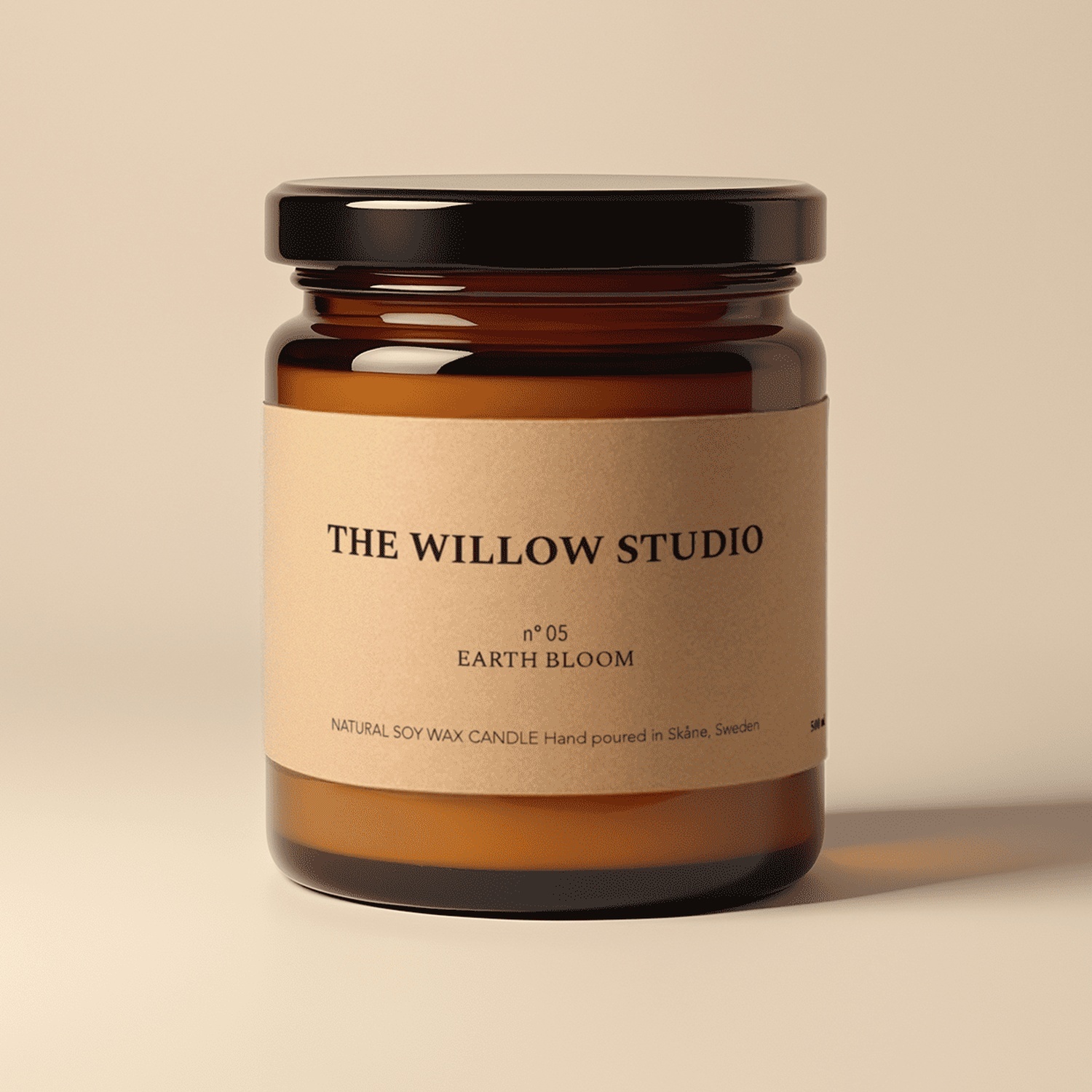 Amber glass candle jar with a kraft paper label for The Willow Studio's Earth Bloom natural soy wax candle