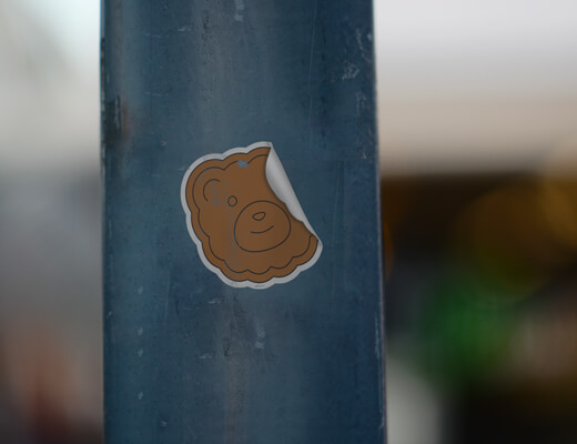 Removable sticker with a bear on a stick.