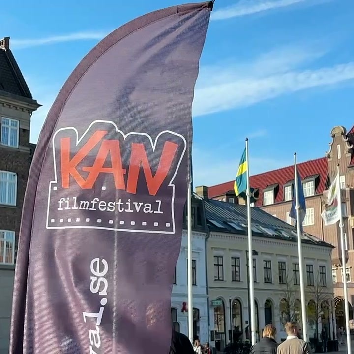 KAN filmfestival beach flag in front of historic buildings and flags on a square in Lund