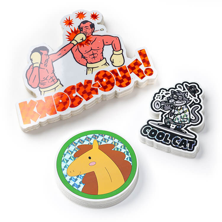 Three prismatic stickers sitting on top of a table